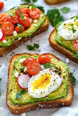 Delicious avocado toast topped with fresh ingredients on a rustic wooden table.
