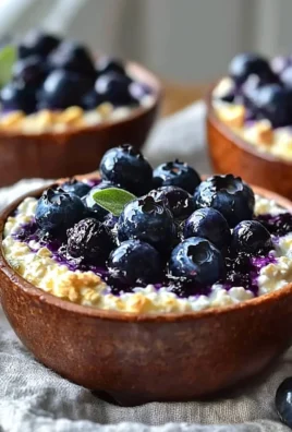 Baked blueberry cottage cheese bowls topped with fresh blueberries and nuts