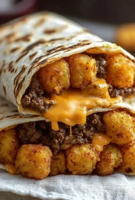 Delicious cheesy potato burritos served on a plate with fresh toppings