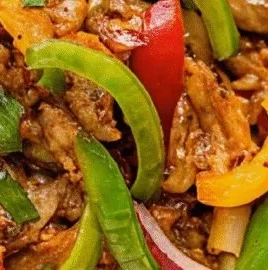 Delicious and colorful crock pot fajitas served on a plate with toppings.
