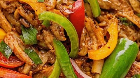 Delicious and colorful crock pot fajitas served on a plate with toppings.