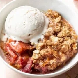 Gluten-free rhubarb crisp topped with oats and served in a bowl