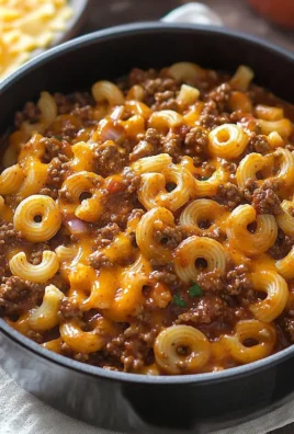 A bowl of homemade Hamburger Helper with ground beef, pasta, and cheese sauce.
