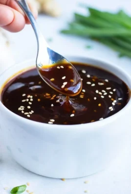 Homemade teriyaki sauce in a small bowl with a brush for glazing