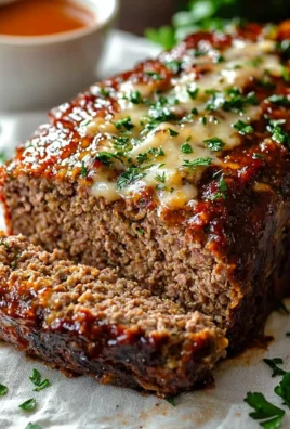 Delicious garlic parmesan meatloaf served with a side of vegetables.