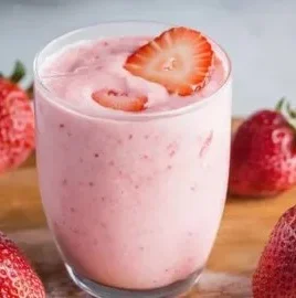 Colorful protein smoothies in glasses with fruit and ingredients on a table