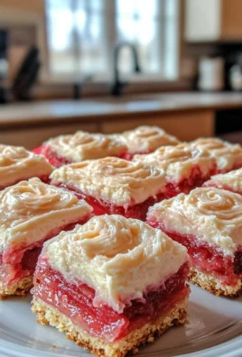 Delicious rhubarb bars topped with cream cheese icing, perfect for dessert lovers