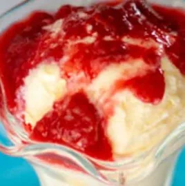 Rhubarb raspberry dessert sauce drizzled over vanilla ice cream.