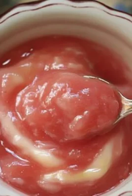 Delicious homemade rhubarb sauce in a glass jar ready to serve.