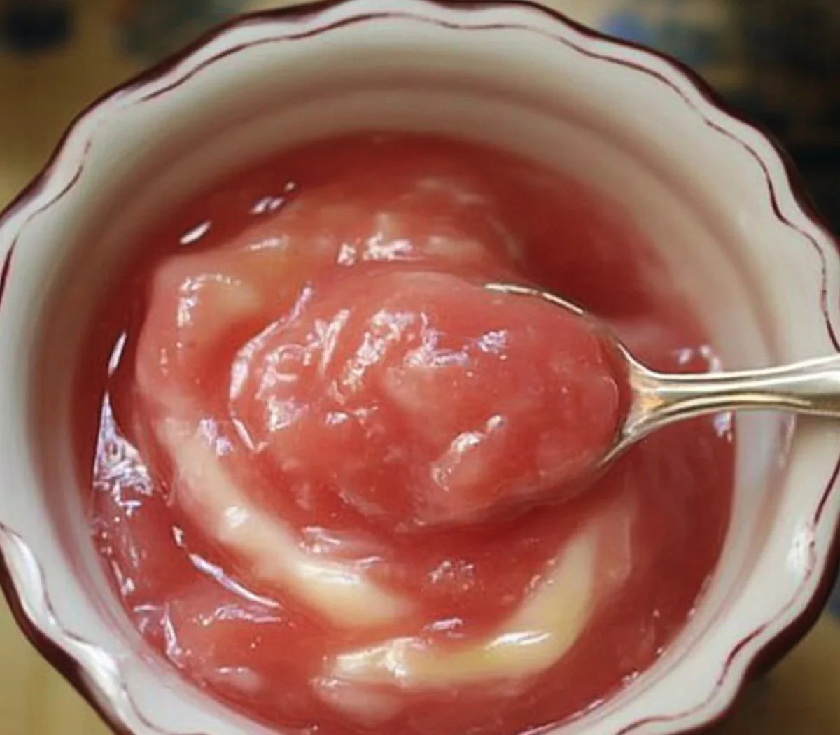 Delicious homemade rhubarb sauce in a glass jar ready to serve.