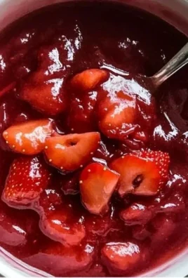 Jar of homemade strawberry rhubarb sauce with fresh strawberries and rhubarb