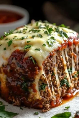 Stuffed Italian meatloaf filled with herbs and cheese on a serving plate