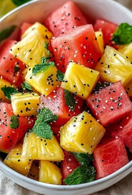 Colorful Watermelon Pineapple Salad with fresh fruits and mint leaves