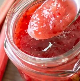 Homemade zesty strawberry rhubarb sauce in a bowl, perfect for desserts.