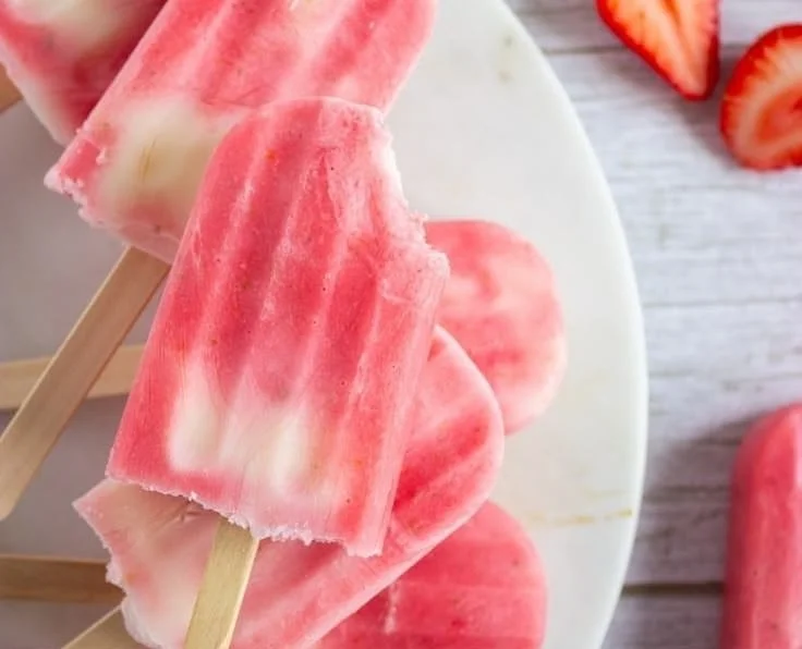 Delicious and refreshing Greek Yogurt Popsicles on a wooden stick