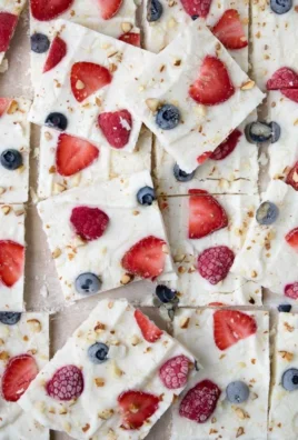 Healthy frozen yogurt bark with fruits and nuts on a vibrant plate