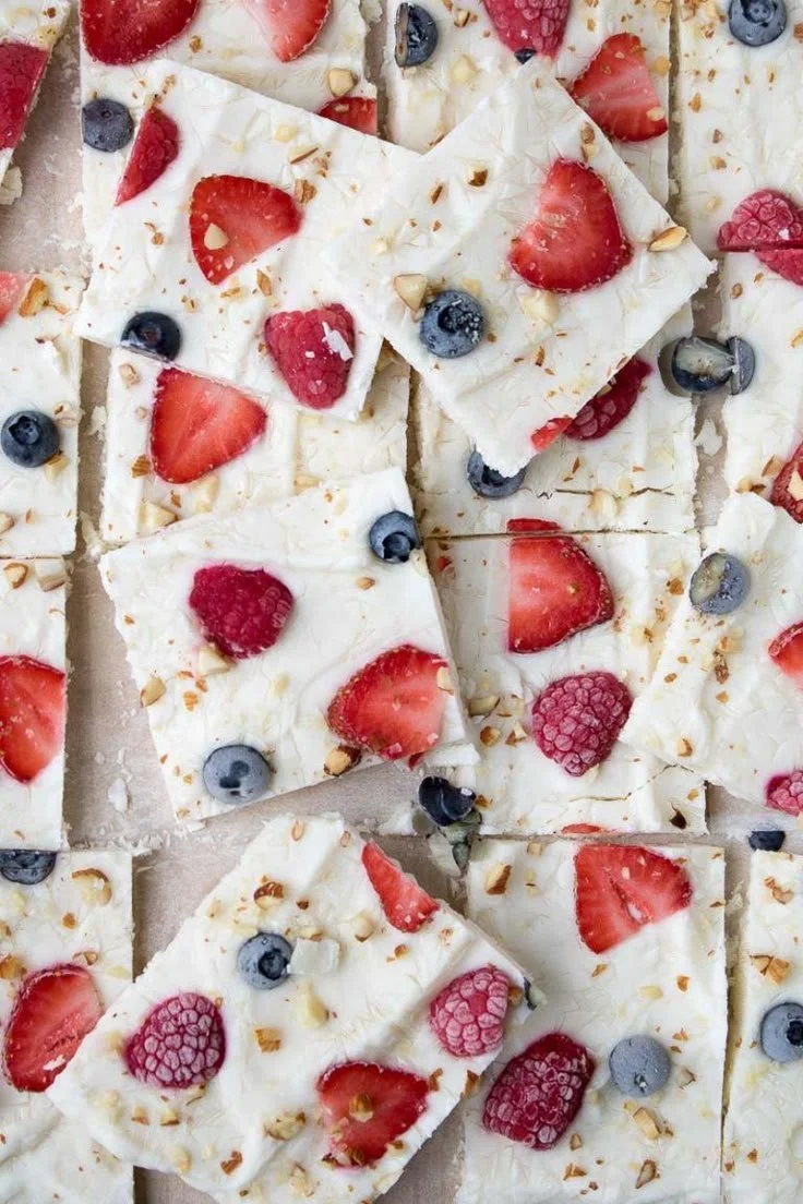 Healthy frozen yogurt bark with fruits and nuts on a vibrant plate