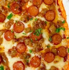 Hot Honey Pepperoni and Sausage Pizza Dip served in a bowl with crispy breadsticks