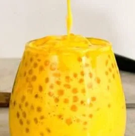 A bowl of Mango Sago topped with fresh mango cubes and coconut milk