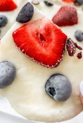Delicious mixed berry yogurt bark topped with fresh berries and yogurt