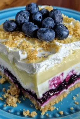 No bake lemon blueberry dessert featuring layers of fresh blueberries and lemon flavor.