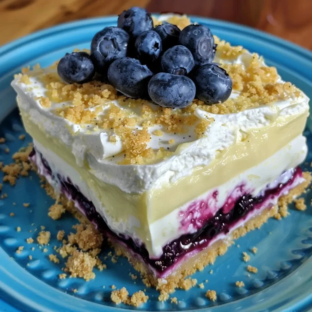 No bake lemon blueberry dessert featuring layers of fresh blueberries and lemon flavor.