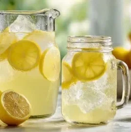 Glass of Old Fashioned Lemonade with lemon slices and mint leaves garnish