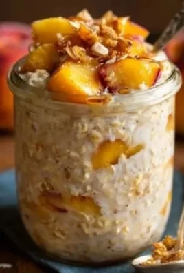 Bowl of Peach Overnight Oats topped with fresh peach slices and chia seeds.
