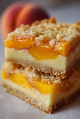 Peaches and Cream Breakfast Bars stacked on a plate, ready to be enjoyed.