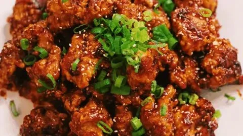 Spicy Honey Garlic Chicken served on a plate with vibrant vegetables