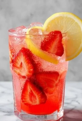 Refreshing glass of homemade strawberry lemonade with fresh strawberries and lemon slices