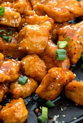 Plate of Sweet Chili Chicken served with rice and vegetables