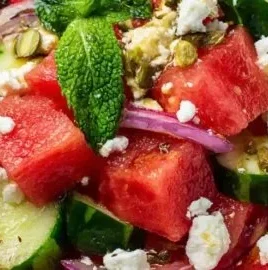Colorful watermelon salad with mint and feta cheese served in a bowl.