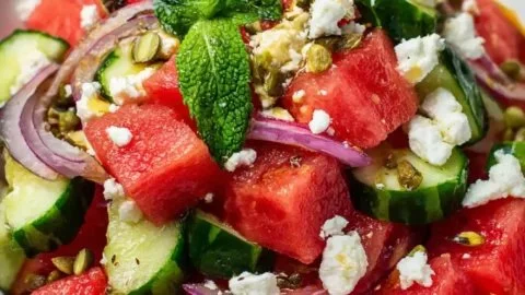 Colorful watermelon salad with mint and feta cheese served in a bowl.
