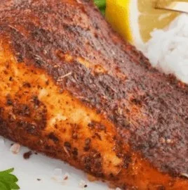 Air fryer blackened salmon served with a side of vegetables