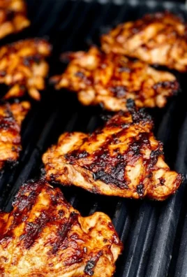 Oven-baked BBQ chicken thighs glazed with sticky sauce on a platter