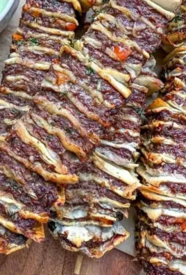 Beef kebab skewers served with cilantro yogurt dip, garnished with fresh herbs.