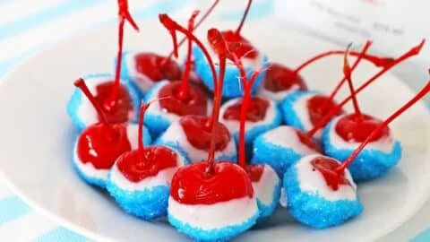 Delicious boozy cherry bombs cocktail served in glass with cherries
