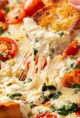 Delicious Caprese Dip with layers of fresh mozzarella, tomatoes, and basil