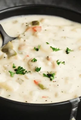 Delicious bowl of clam chowder with clams, potatoes, and herbs
