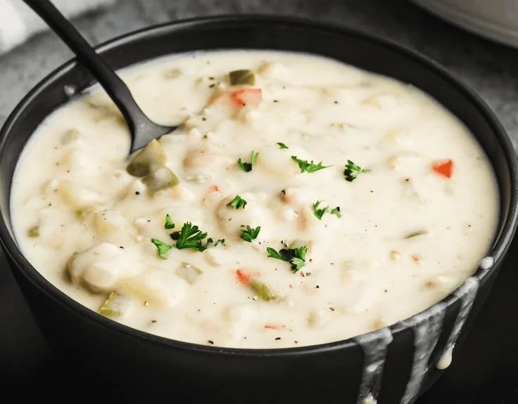 Delicious bowl of clam chowder with clams, potatoes, and herbs