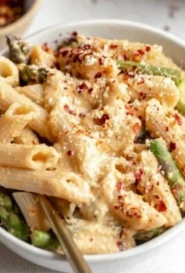 Creamy lemon white bean pasta dish served with fresh herbs and a sprinkle of cheese