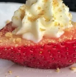 Deviled strawberries with cheesecake filling served on a plate
