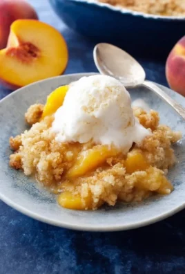 Delicious homemade peach cobbler served in a dish, perfect for dessert.