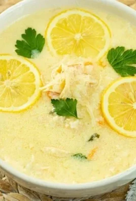 Delicious Greek chicken Avgolemono soup served in a bowl with lemon and herbs