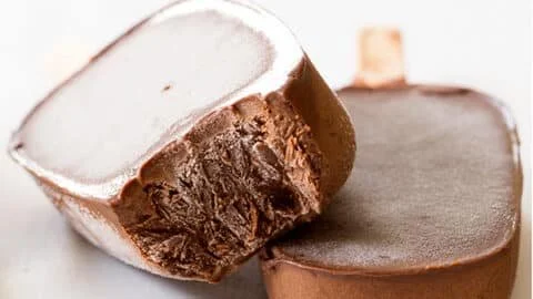 Delicious homemade healthy fudgesicles served on a wooden table