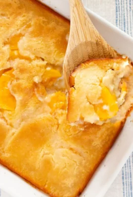 Delicious homemade peach cobbler fresh from the oven with golden crust and juicy peaches.