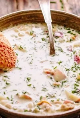 Bowl of creamy New England clam chowder topped with parsley