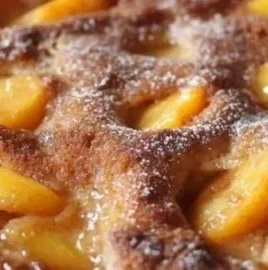 Delicious homemade peach cobbler served in a dish with fresh peaches