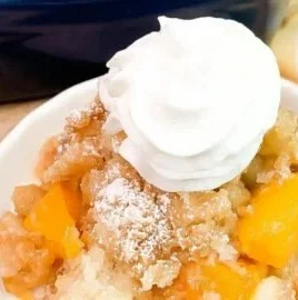 Delicious peach cobbler topped with a brown sugar crumble crust
